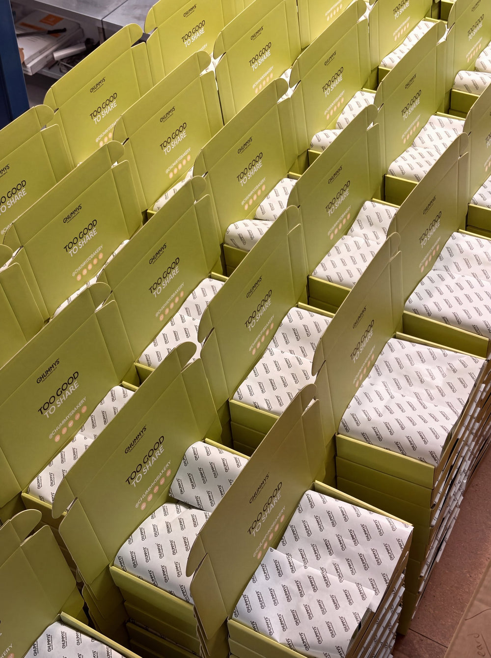 Rows of open boxes lined with tissue, ready for the day's run